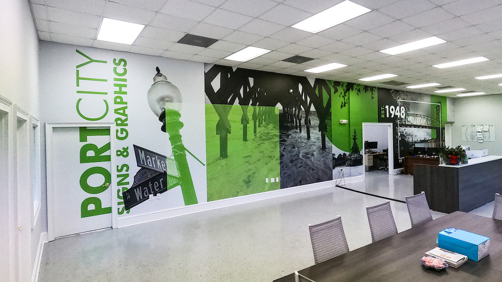 Interior office wall mural that is branded and welcomes clients in a professional aesthetic while still adding a pop to the signage and space tastefully